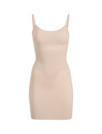 The Commando Zone Smoothing Full Slip is a beige, sleeveless bodycon dress with thin straps and targeted compression for a smooth silhouette, shown against a plain white background.