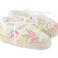 The Baby Girls’ Liberty Fabric Espadrille Slipper from Tartine et Chocolat is crafted from charming Liberty fabric, features white laces, a delicate pastel floral print, and classic rope-style soles for the perfect cotton espadrilles look.