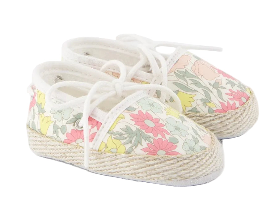 The Baby Girls’ Liberty Fabric Espadrille Slipper from Tartine et Chocolat is crafted from charming Liberty fabric, features white laces, a delicate pastel floral print, and classic rope-style soles for the perfect cotton espadrilles look.
