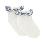 A pair of Tartine et Chocolat Baby Liberty Print Socks in white cotton, designed for girls with ruffled cuffs and a charming blue, pink, and green Liberty print floral pattern.