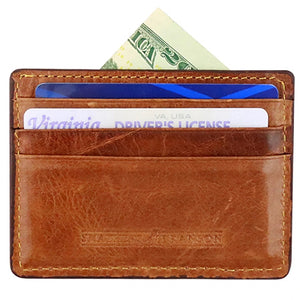 A Smathers & Branson Crossed Clubs Card Wallet in brown leather, hand-stitched, with cash, two credit cards, and a visible Virginia driver’s license in its slots.