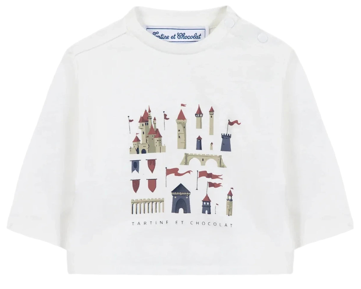 The Tartine et Chocolat Baby Boys’ and Boys’ Castle Print Cotton T-Shirt is a white, long-sleeved top made from soft unbleached cotton, featuring an enchanting castle illustration with towers and red flags, and the “Tartine et Chocolat” logo elegantly written beneath the print.