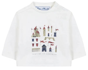 The Tartine et Chocolat Baby Boys’ and Boys’ Castle Print Cotton T-Shirt is a white, long-sleeved top made from soft unbleached cotton, featuring an enchanting castle illustration with towers and red flags, and the “Tartine et Chocolat” logo elegantly written beneath the print.