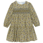 Introducing the Girls’ Liberty Embroidery Round Neck Cotton Dress by Tartine et Chocolat—this long-sleeved dress features a smocked bodice, gathered skirt, and zipper back closure. Its delicate floral embroidery in green, brown, and purple hues on a cream background brings to mind the beauty of an English garden.