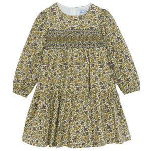 Introducing the Girls’ Liberty Embroidery Round Neck Cotton Dress by Tartine et Chocolat—this long-sleeved dress features a smocked bodice, gathered skirt, and zipper back closure. Its delicate floral embroidery in green, brown, and purple hues on a cream background brings to mind the beauty of an English garden.