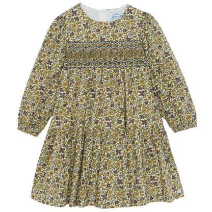Introducing the Girls’ Liberty Embroidery Round Neck Cotton Dress by Tartine et Chocolat—this long-sleeved dress features a smocked bodice, gathered skirt, and zipper back closure. Its delicate floral embroidery in green, brown, and purple hues on a cream background brings to mind the beauty of an English garden.