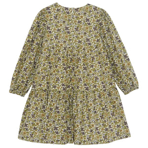 The Girls’ Liberty Embroidery Round Neck Cotton Dress by Tartine et Chocolat is a long-sleeved, knee-length dress adorned with a vibrant yellow, purple, and green floral print on a white background, inspired by an English garden and finished with delicate Liberty flower embroidery.