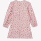 Tartine et Chocolat Girls’ Flowery Print Cotton Dress—a long-sleeve, knee-length dress featuring a pink floral print on a white background—is displayed laid flat on a white surface.