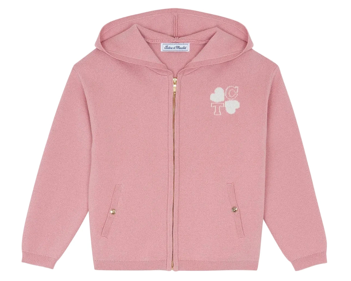 A stylish addition to any cotton tracksuit ensemble, the Tartine et Chocolat Girls’ Wool Hood Cotton Jogging Suit features a pink hooded zip-up sweater with front pockets and gold buttons, adorned with embroidered white hearts and the letters “C” and “T” on the chest—bringing Paris Mon Amour–inspired chic flair to her look.