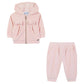 Tartine et Chocolat Baby Girls’ Jogging Suit Outfit—a light pink toddler tracksuit including a hooded jacket adorned with two charming bows and matching pants, both crafted from soft fabric—makes an adorable addition to your baby clothing collection.