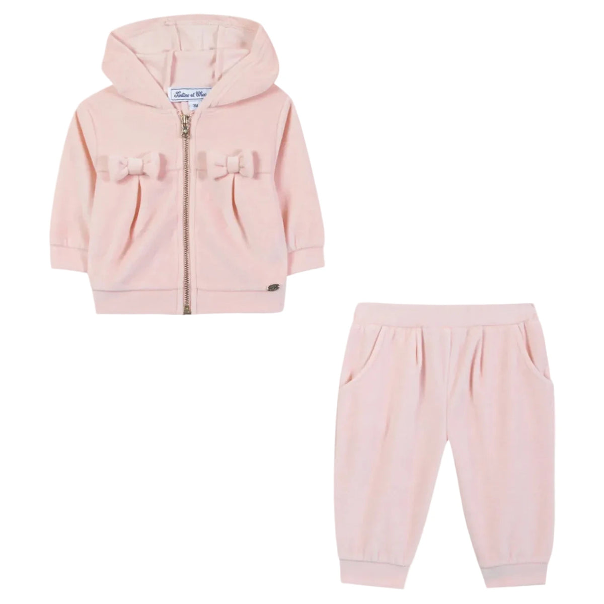 Tartine et Chocolat Baby Girls’ Jogging Suit Outfit—a light pink toddler tracksuit including a hooded jacket adorned with two charming bows and matching pants, both crafted from soft fabric—makes an adorable addition to your baby clothing collection.