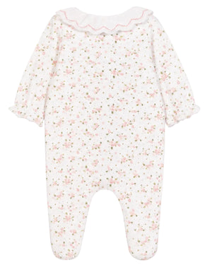 The Tartine et Chocolat Baby Girls’ Ruffle Collar Pajama is a white onesie with long sleeves and feet, adorned with a pink floral pattern and a scalloped collar trimmed in pink. Crafted from soft fabric for comfortable sleep, it features gently ruffled cuffs for an extra touch of charm.