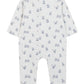 Introducing the Tartine et Chocolat Baby Boys’ Ribbed Knit Pajama—a white, long-sleeved onesie with covered feet, made from soft unbleached cotton. This pajama features an all-over pattern of small blue teddy bear motifs and baby accessories. The garment is displayed flat with the back facing up.