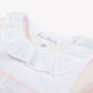 Close-up of the Baby Girls’ Peter Pan Collar Gathered Pajamas by Tartine et Chocolat, crafted from soft cotton and featuring a white ruffled Peter Pan collar, delicate pink embroidered details, and a visible “Tartine et Chocolat” label.