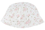 The Tartine et Chocolat Beanie is a white baby hat adorned with a delicate pattern of small pink flowers and green stems, crafted from soft unbleached cotton and featuring a folded brim.
