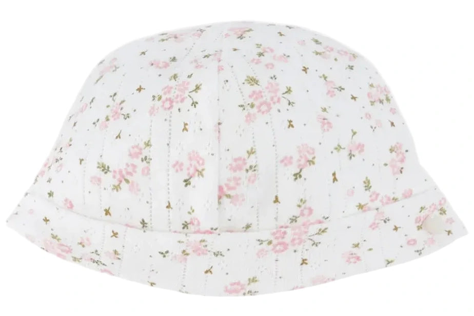 The Tartine et Chocolat Beanie is a white baby hat adorned with a delicate pattern of small pink flowers and green stems, crafted from soft unbleached cotton and featuring a folded brim.