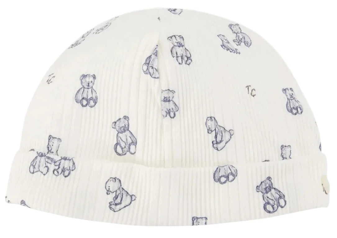 This Tartine et Chocolat Beanie is crafted from soft, unbleached cotton and features a white ribbed design with a folded brim. Delicate light blue teddy bear illustrations add a charming touch, making it perfect for a newborn boy.