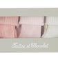 A box labeled “Tartine et Chocolat” contains the Cotton Sock Set, featuring three pairs of ribbed toddler socks in pink, light pink, and white—specially designed for sensitive baby skin and showcased behind a clear window.