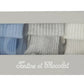 Presented in a rectangular box with a window, the Tartine et Chocolat Cotton Sock Set features three pairs of ribbed baby socks in blue, gray, and white. Designed for sensitive baby skin, these toddler socks are packaged with “Tartine et Chocolat” printed on the box.