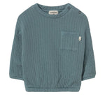 The Cozmo Baby Boys’ Chipre Quilted Sweatshirt is a teal, long-sleeve organic cotton sweatshirt featuring a chest pocket with a small brand label, two shoulder snaps for easy changing, and cozy quilted fabric—ideal for comfy fall and winter baby clothes.