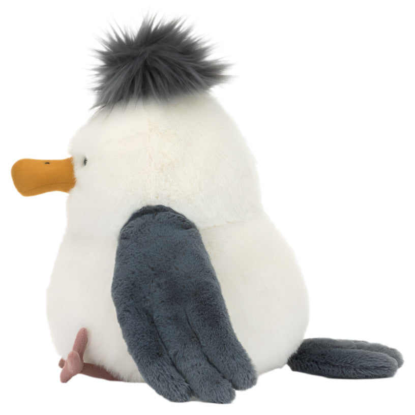 The Jellycat Chip Seagull plush toy, created by Jellycat, showcases a white body with an orange beak, fluffy gray hair, dark gray wings, and a small tail. Its soft cream fur makes it the perfect cuddly companion for a beach picnic.