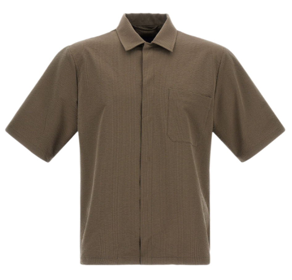 The Herno Seersucker Camp Shirt is a short-sleeved, collared, olive-brown shirt with a single chest pocket and versatile cut, displayed against a white background.