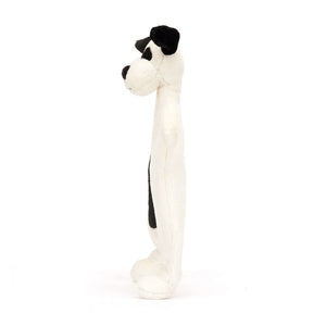 The Jellycat Bashful Black & Cream Puppy Comforter, crafted from recycled fibers, stands upright in a side view against a plain white background—an ideal cozy plush companion for newborns.