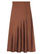 The CO Slip Silk Skirt is a brown satin midi skirt featuring a high waist and a flowy, A-line silhouette reminiscent of a classic bias-cut slip skirt, displayed against a white background.