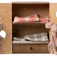 Two Ballet Mice in Dance Studio by Maileg stand beside an open mouse house wardrobe with bunk beds and folded blankets inside.