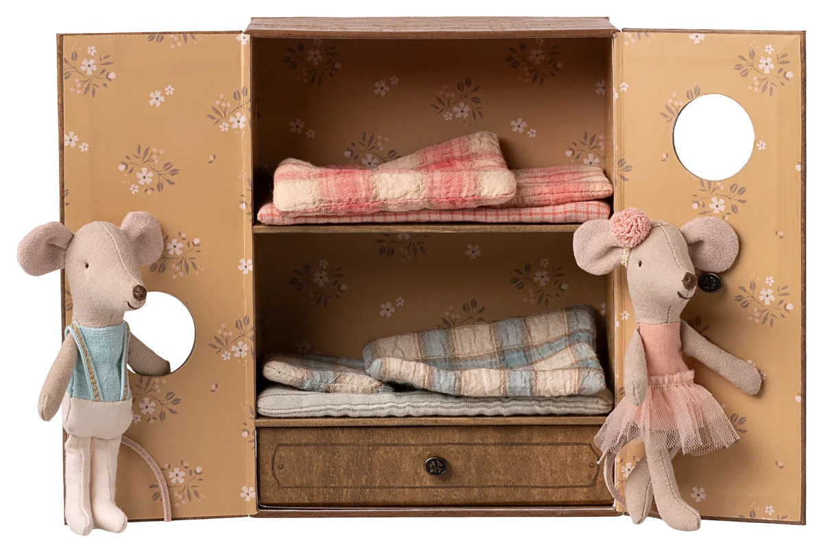 Two Ballet Mice in Dance Studio by Maileg stand beside an open mouse house wardrobe with bunk beds and folded blankets inside.