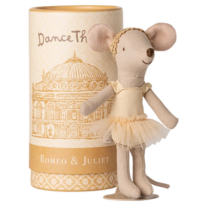 A Maileg Ballet Dancer Mouse, Big Sister, poses gracefully in front of a cylindrical "Dance The Romeo & Juliet" box with a building illustration—ideal for display.