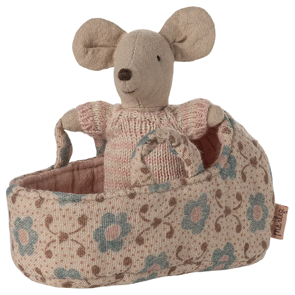 The Maileg Baby Mouse in Carry Cot - Rose features a tiny mouse in a pink outfit nestled in a floral-patterned carry cot.