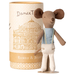 A Maileg Ballet Dancer Mouse, Big Brother, in a blue top and white pants stands before a cylindrical "Romeo & Juliet" box featuring a building illustration.