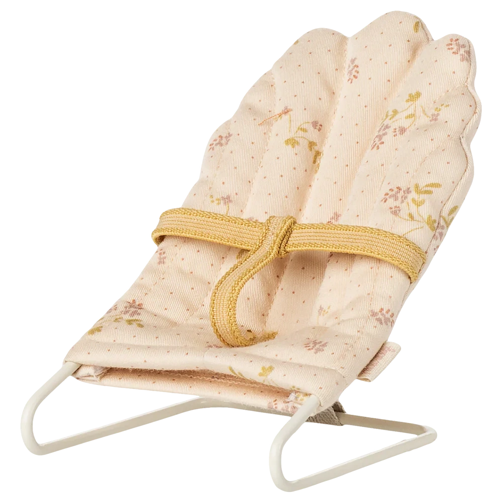 The Maileg Babysitter, Micro - Off White is a small fabric-covered baby bouncer with a floral pattern, yellow harness, and white metal frame, ideal for micro-sized rabbits or bunnies. Shown against a white background.