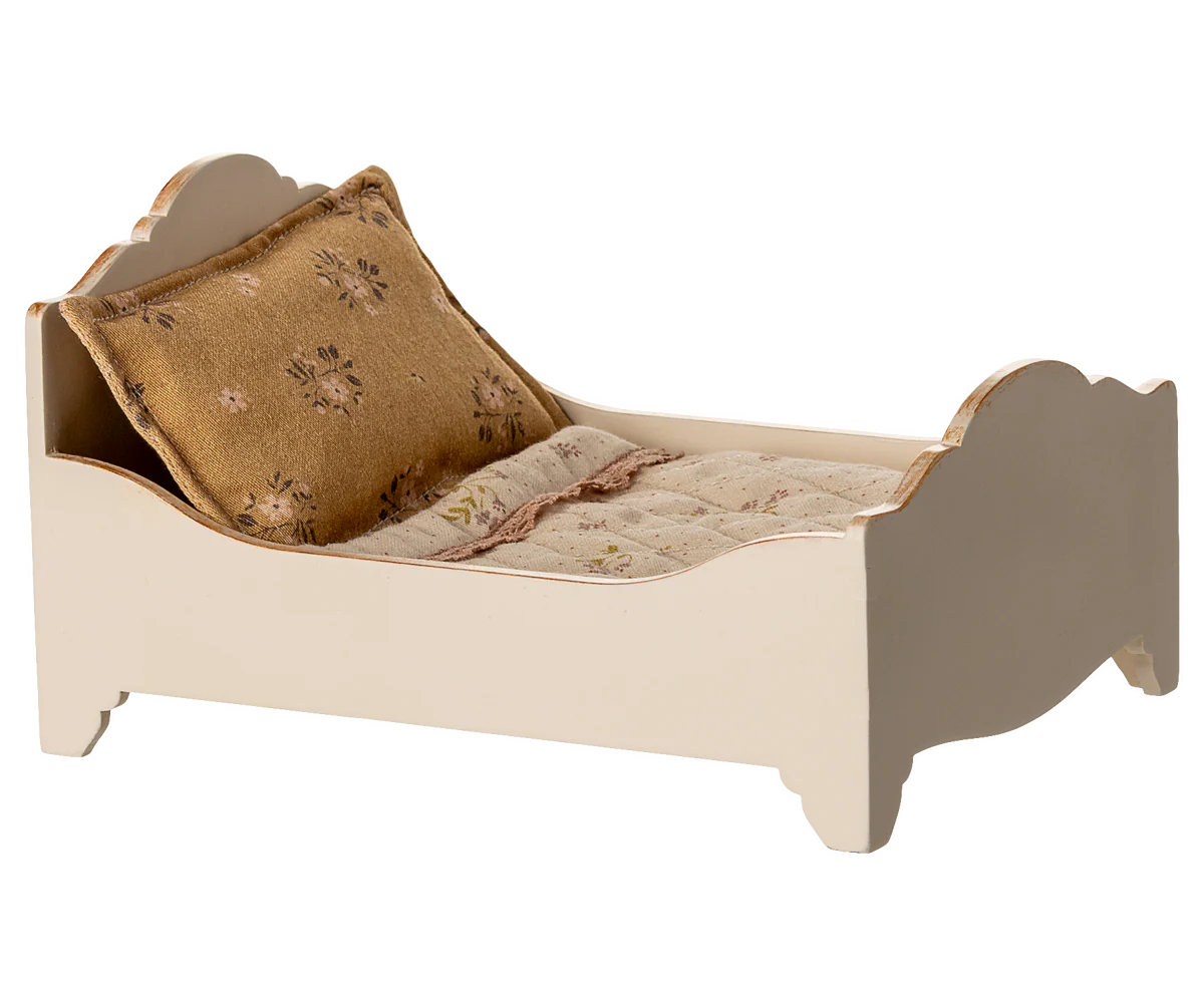 The Maileg Bed, Mouse - Off White is a small cream wooden dollhouse bed with floral mattress and pillow, perfect as a cozy bed for mice or tiny toys.