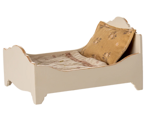 The Maileg Bed, Mouse - Off White is a small, cream-colored wooden bed with a patterned pillow and blanket, perfect as a cozy sleeping spot for mice.