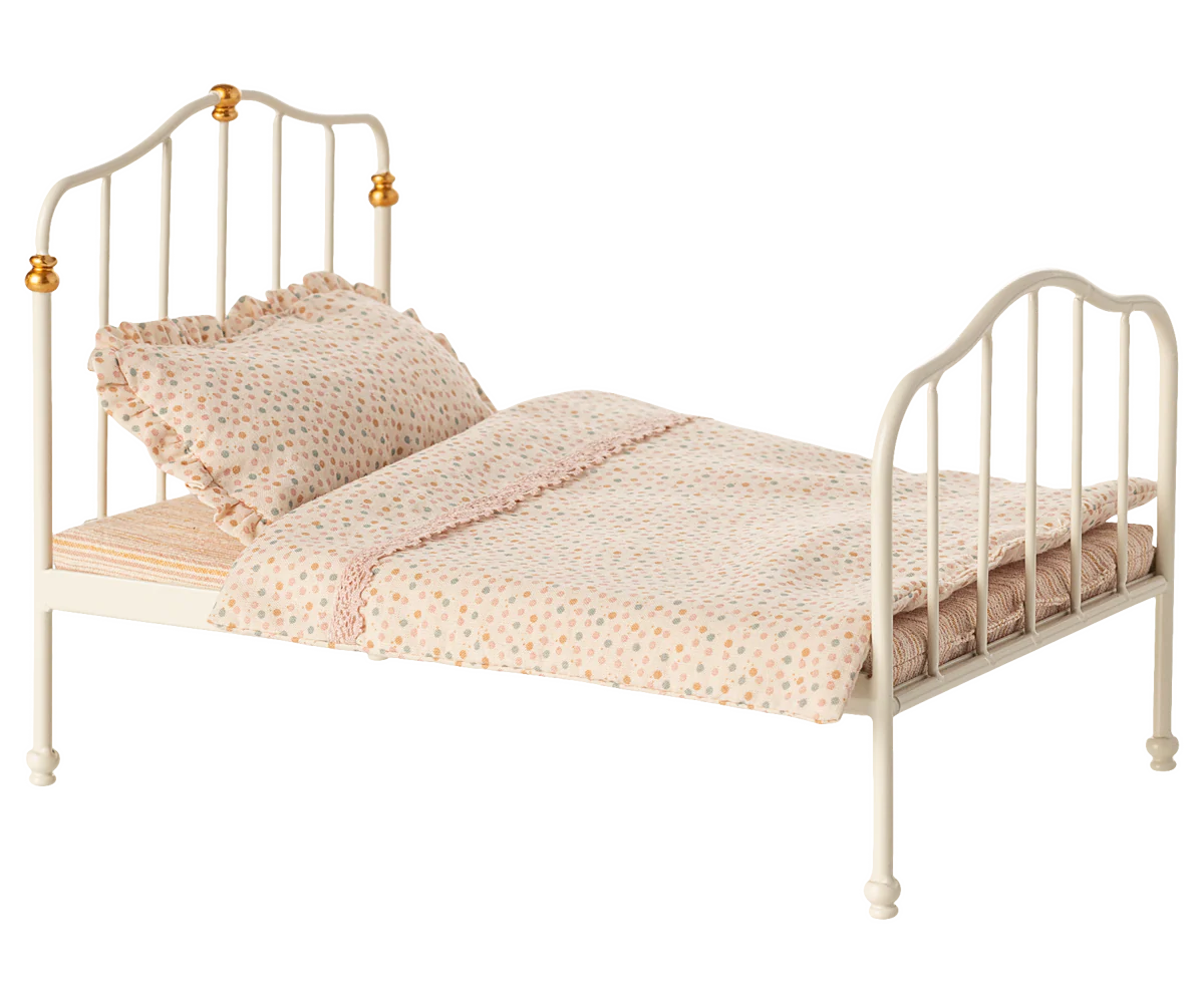 The Maileg Vintage Bed, Mouse - Off White, features gold accents, patterned bedding, and a ruffled pillow, displayed on a plain background.