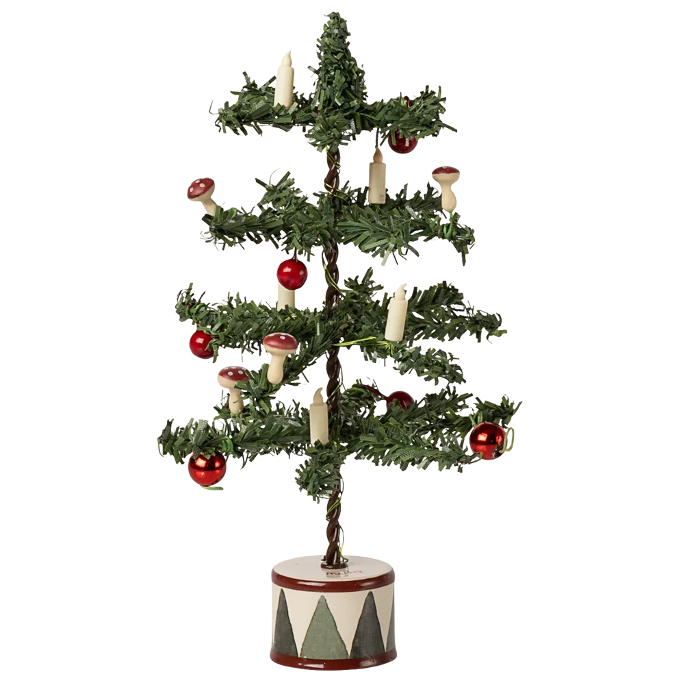 The Maileg Christmas Tree, Mouse is a small artificial tree with red baubles, candle-shaped ornaments, and mushrooms, set in a round white base decorated with black triangles.
