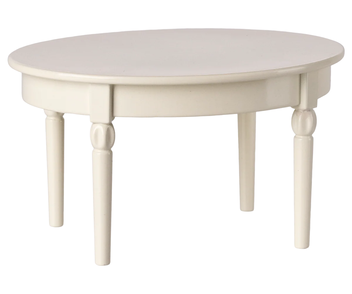 The Maileg Vintage Dining Table, Mouse - Off White, is a round, white wooden table with four legs—ideal as dollhouse furniture—shown against a plain background.