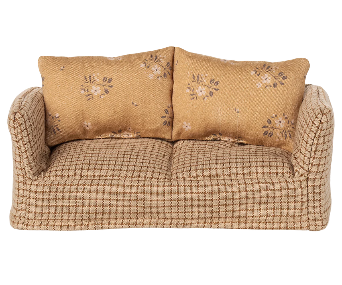 The Maileg Couch, Mouse – Mable is a small, soft sofa with a checkered beige pattern and two floral tan cushions, perfect for cozying up in your Mouse hole Farmhouse.