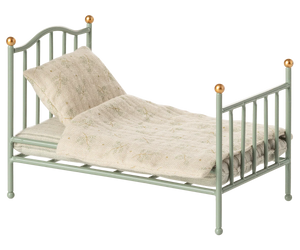The Maileg Vintage Single Bed, Mouse - Mint features gold-tipped posts and comes with a patterned beige blanket and pillow—a charming, cozy bed for your tiny friends.