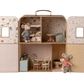 Introducing the Maileg SuitCasa: a portable house crafted as a miniature dollhouse with four rooms, complete with tiny furniture such as chairs, tables, and beds. The set includes little sister and brother mouse figures dressed in striped clothes.