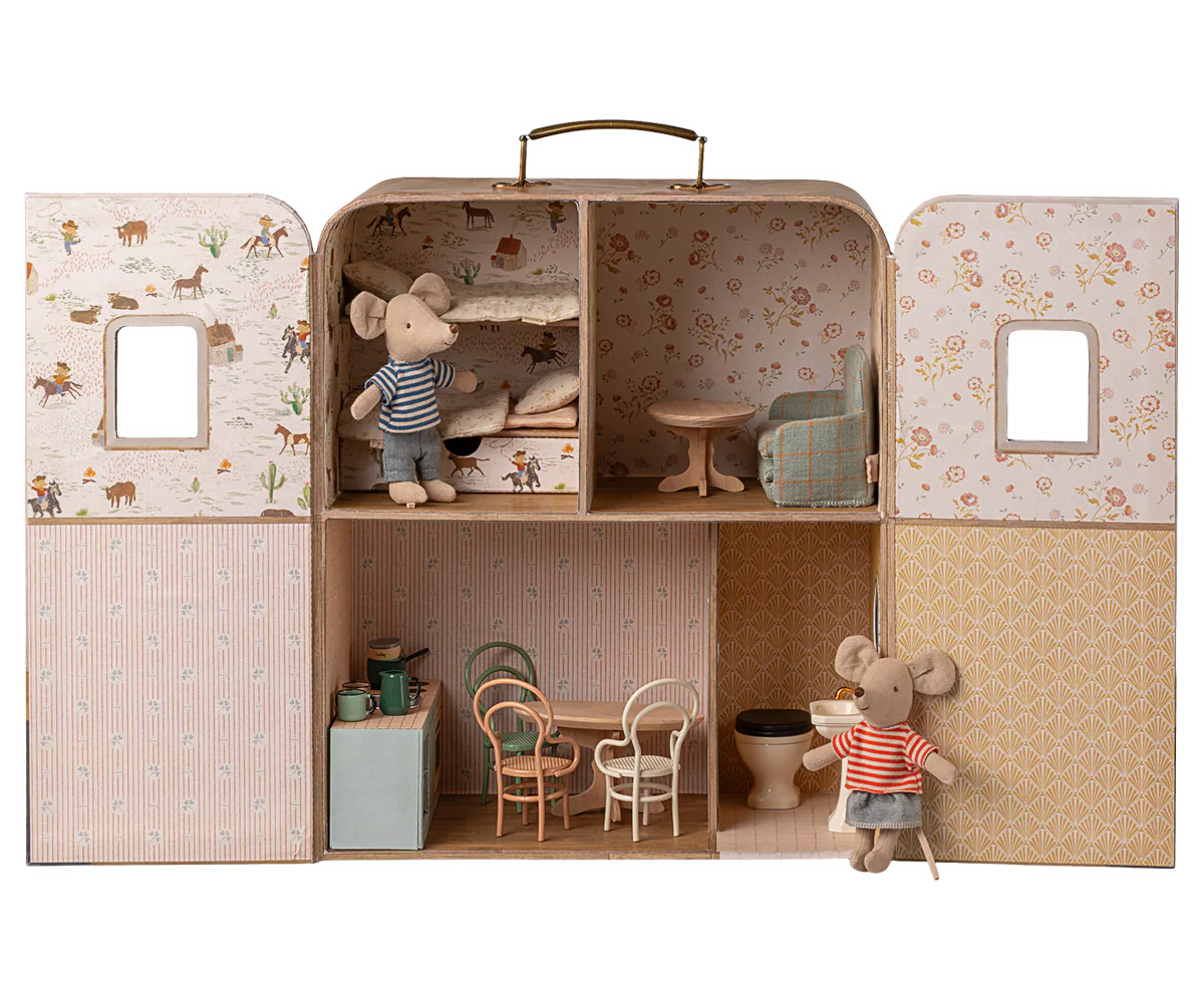 Introducing the Maileg SuitCasa: a portable house crafted as a miniature dollhouse with four rooms, complete with tiny furniture such as chairs, tables, and beds. The set includes little sister and brother mouse figures dressed in striped clothes.