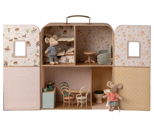Introducing the Maileg SuitCasa: a portable house crafted as a miniature dollhouse with four rooms, complete with tiny furniture such as chairs, tables, and beds. The set includes little sister and brother mouse figures dressed in striped clothes.