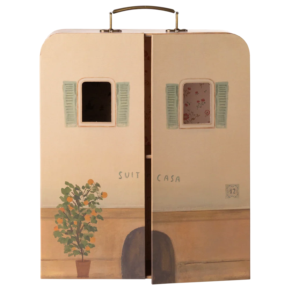 A whimsical Maileg SuitCasa suitcase, designed to resemble a charming house facade with two windows, green shutters, a potted plant, and partially open doors revealing a floral interior—perfect for welcoming Little Sister and Brother Mouse and their collection of miniature furniture.