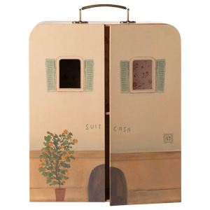 A whimsical Maileg SuitCasa suitcase, designed to resemble a charming house facade with two windows, green shutters, a potted plant, and partially open doors revealing a floral interior—perfect for welcoming Little Sister and Brother Mouse and their collection of miniature furniture.
