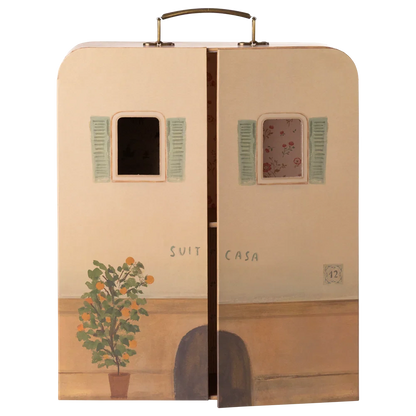 A whimsical Maileg SuitCasa suitcase, designed to resemble a charming house facade with two windows, green shutters, a potted plant, and partially open doors revealing a floral interior—perfect for welcoming Little Sister and Brother Mouse and their collection of miniature furniture.