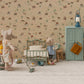 Two toy mice in a miniature room: one vacuums while the other stands by a Maileg Vintage Single Bed, Mouse - Mint. The scene features Maileg bedding, a green cabinet, scattered items, and wallpaper with western-themed illustrations.