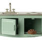 A miniature Mint Kitchen - Mouse set by Maileg, featuring a green metal stove and sink, with an open toy oven door revealing a tiny pie inside—perfect for the Mouse Hole Farmhouse.