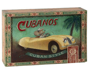 Maileg’s "Grandma and Grandpa Mice in Cigarbox" comes in a rectangular box adorned with charming artwork of the two mice driving a yellow convertible beneath a palm tree—a playful scene that invites grandmice (and their families) to dream up tropical adventures from the comfort of their cozy cigarbox bed.